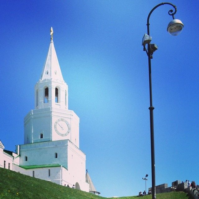 clear sky, blue, religion, church, place of worship, building exterior, spirituality, built structure, architecture, cross, low angle view, copy space, tower, spire, dome, day, street light