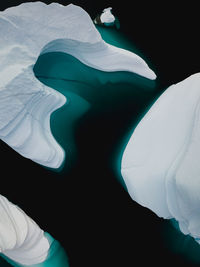 High angle view of icebergs in sea