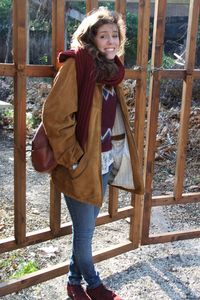 Portrait of teenage girl standing against railing