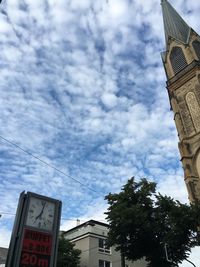 Low angle view of building against cloudy sky