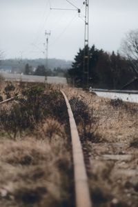 Surface level of railroad tracks against sky