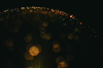 Abstract image of illuminated fiber optics against black background