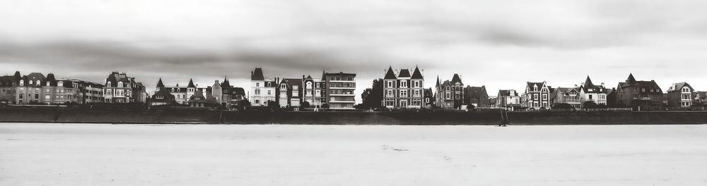 Panoramic view of buildings in city against sky