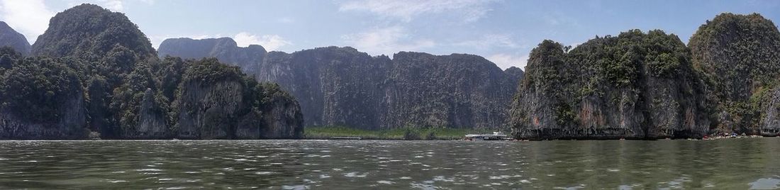 Scenic view of sea with mountain in background
