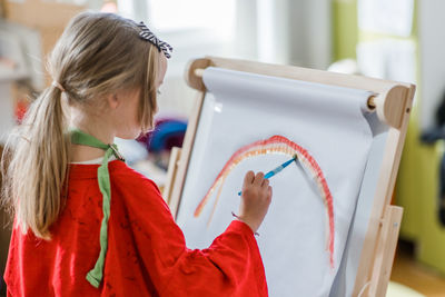 Rear view of woman using digital tablet