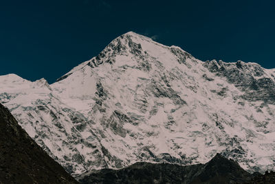 Scenic view of snowcapped mountains against clear blue sky