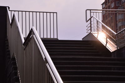 Low angle view of staircase by building against sky