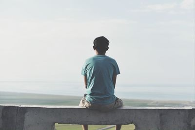 Rear view of man standing on beach