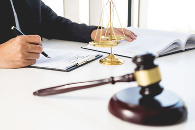 Close-up of man sitting on table