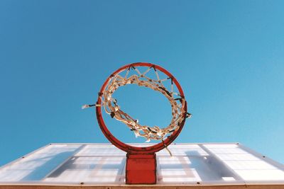 Low angle view of basketball hoop against clear blue sky