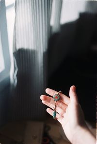 Midsection of person holding hands at home