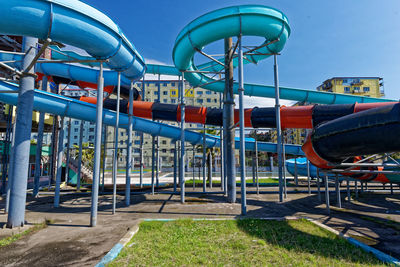 Metallic structure in playground against blue sky