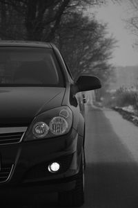 Close-up of car on road against sky