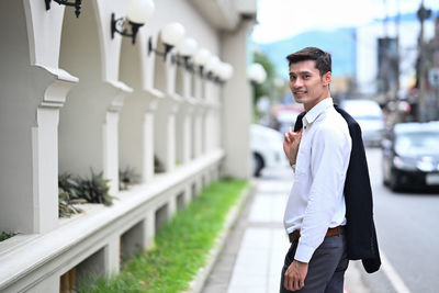 Portrait of businessman standing in city