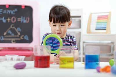 Cute girl playing with toy at home