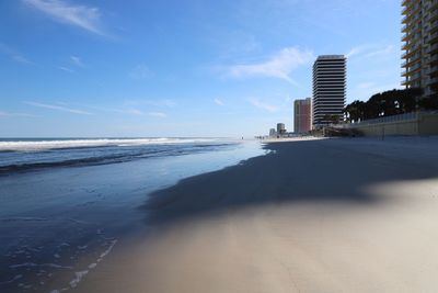 Scenic view of beach against sky in city