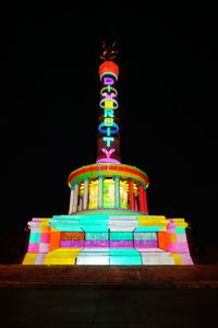 Low angle view of illuminated ferris wheel at night