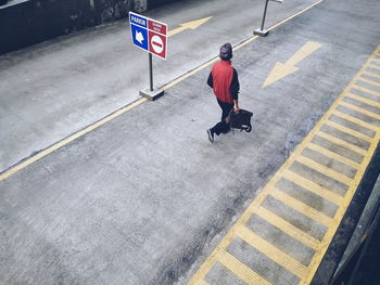 High angle view of man walking on road