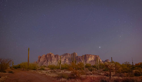 Scenic view of land against clear sky at night