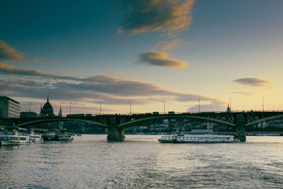 View of bridge over river against cloudy sky