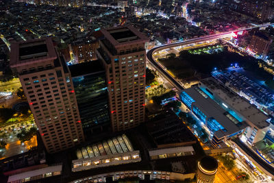 High angle view of city lit up at night