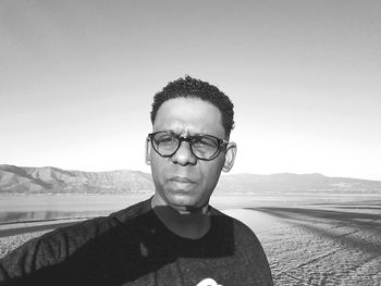 Portrait of young man against mountains against sky