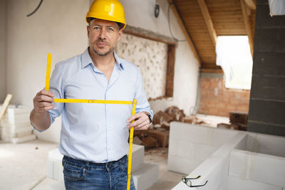 Portrait of man working at construction site