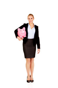 Portrait of young woman standing against white background