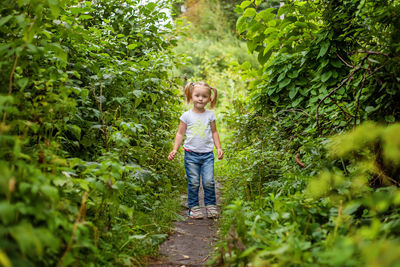 Rear view of woman walking in forest