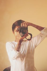 Young man holding camera