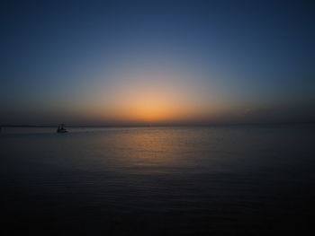 Scenic view of sea against clear sky during sunset