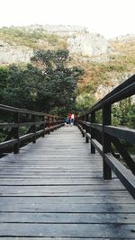 Rear view of man on footbridge