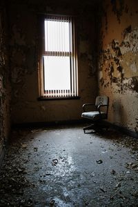 Abandoned chair in empty room