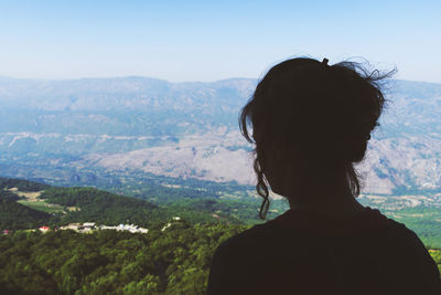 Rear view of woman against mountain range