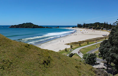 Scenic view of beach against clear blue sky