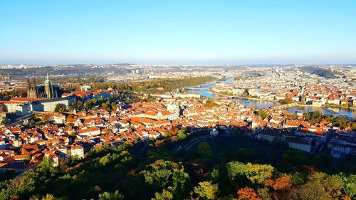 High angle view of houses in town against clear sky