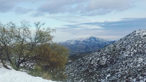 Scenic view of mountains against cloudy sky