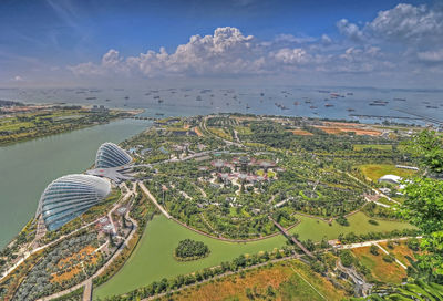 High angle view of town by sea against sky