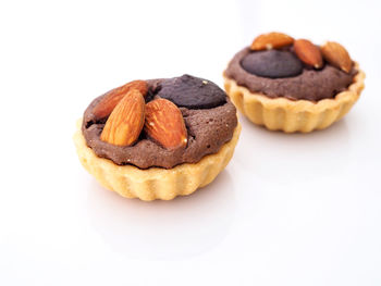 Close-up of cookies in plate against white background