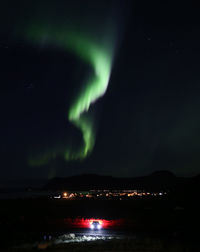 Scenic view of illuminated mountain against sky at night