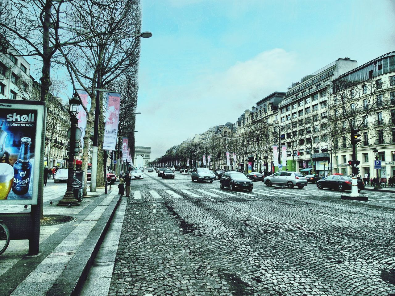 CARS ON CITY STREET AGAINST SKY IN BACKGROUND