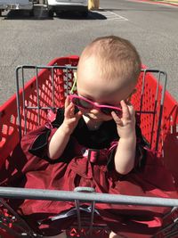 Full length of cute boy sitting outdoors