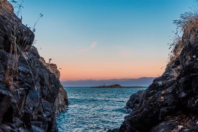 Scenic view of sea and rocks against sky