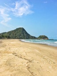 Scenic view of beach against blue sky