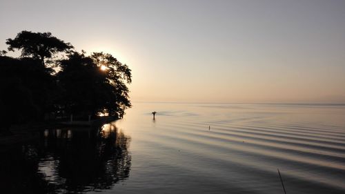 Scenic view of lake against sky during sunset