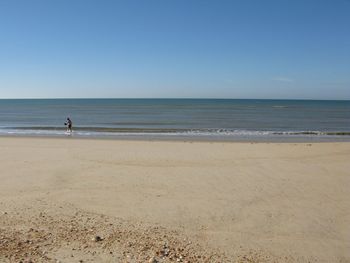 Scenic view of beach against clear sky