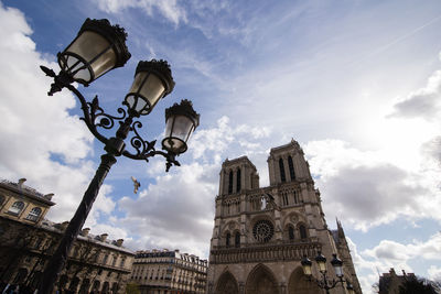 Low angle view of building against cloudy sky