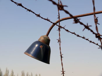 Low angle view of metal against sky