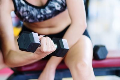 Midsection of woman exercising at gym