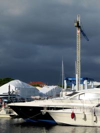 View of harbor against cloudy sky